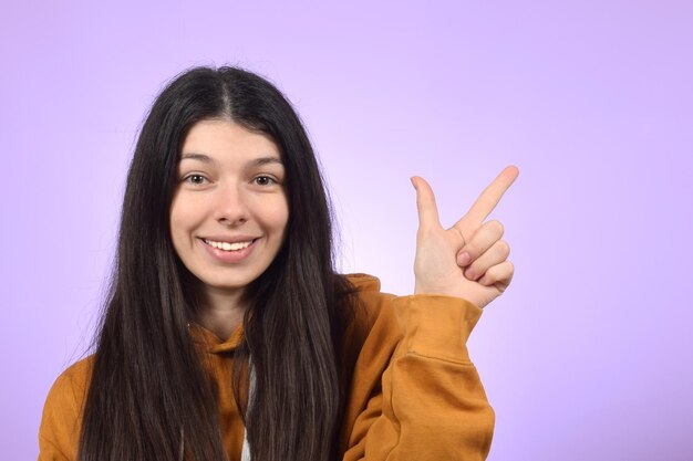 A woman points to the left with her finger pointing to the right