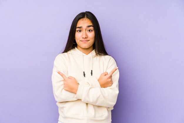 Woman points sideways in studio