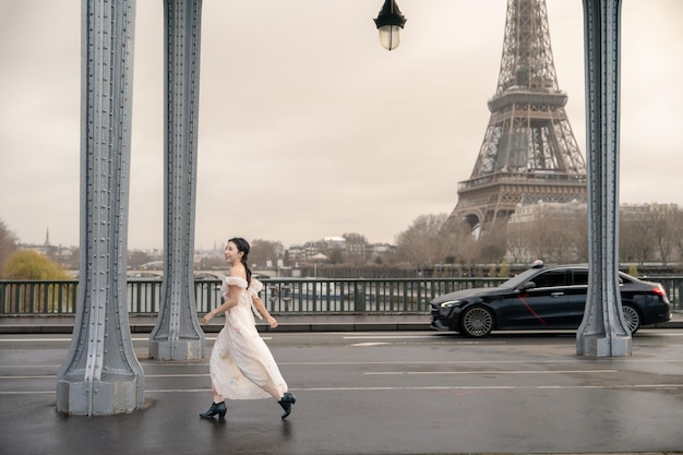 Woman portrait under Bir Hakeim bridge with Eiffel tower Paris France