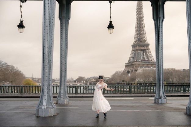 Woman portrait under Bir Hakeim bridge with Eiffel tower Paris France