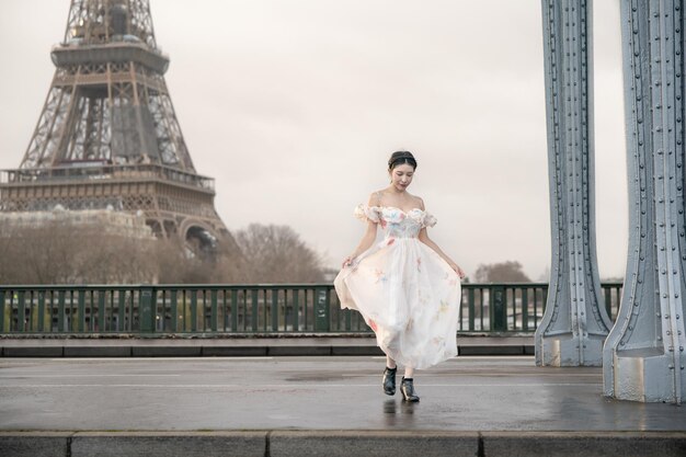 Woman portrait under Bir Hakeim bridge with Eiffel tower Paris France