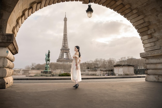 Woman portrait under Bir Hakeim bridge with Eiffel tower Paris France