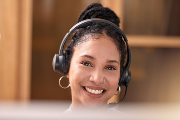 Woman portrait and face smile in call center with headphones for customer service support and telemarketing at the office Happy female consultant agent and smiling with headset for online advice