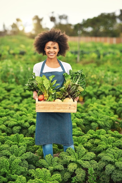 Woman portrait farmer and box of produce in nature sustainable nutrition and crate of organic vegetables Female person farm and outdoor for harvest in Argentina agriculture and countryside crops