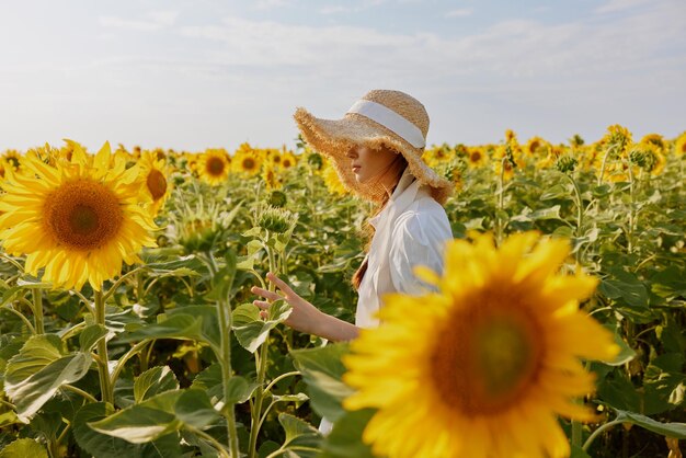 Woman portrait In a field with blooming sunflowers landscape High quality photo