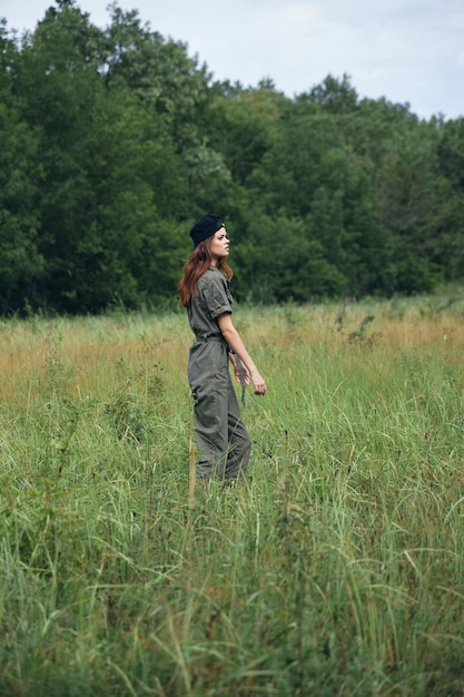 Woman portrait on nature Walk in the field against the background of trees