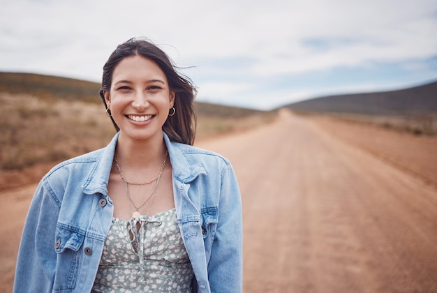 Woman portrait smile and countryside travel for holiday break vacation or road adventure journey in the outdoors Happy female traveler smiling for fun traveling in joy for outing in dessert safari