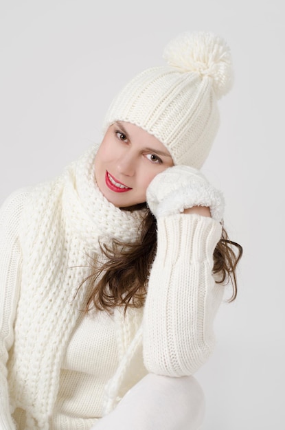 Woman portrait in white winter clothes close up