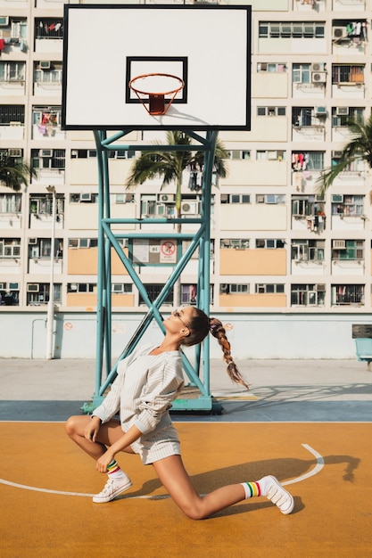 woman posing on Basketball Court in Hong Kong city