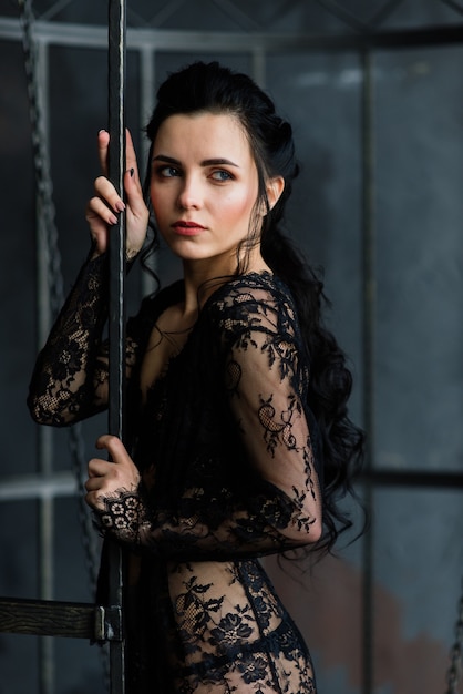 Woman posing in black lace lingerie.