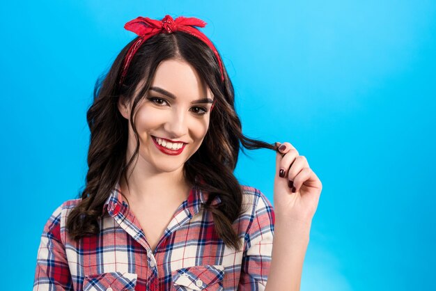 The woman posing on the blue background