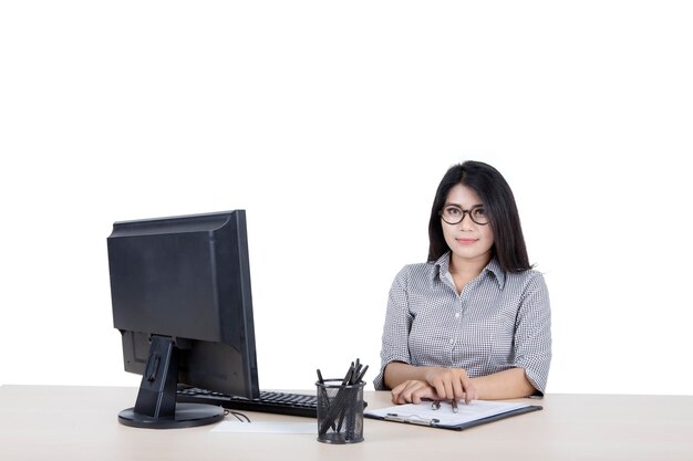 Woman posing at camera while working on a desktop