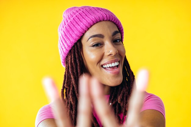 Woman posing on colored backgrounds in studio wearing trendy clothes