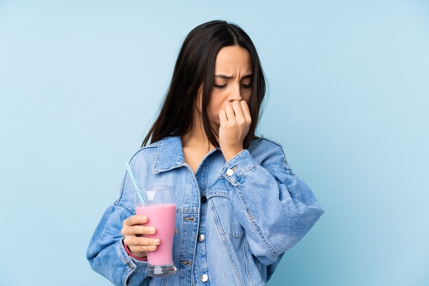 WoMan posing holding a milkshake