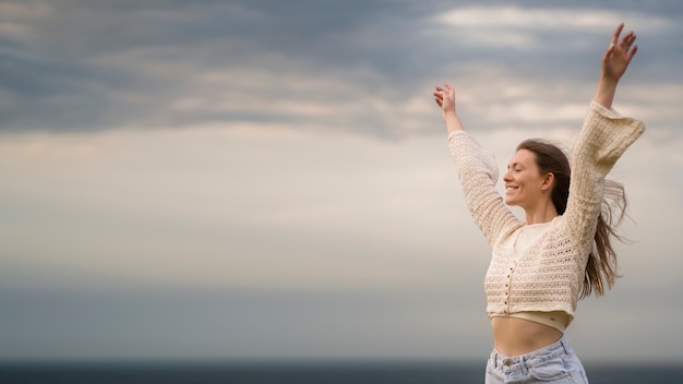 Woman posing outdoors side view