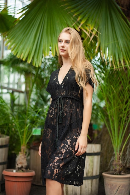 Woman posing in pareo bohemian summer dress near tropic trees