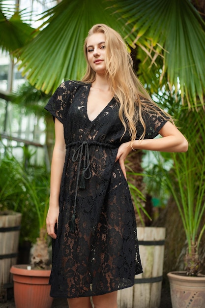 Woman posing in pareo bohemian summer dress near tropic trees