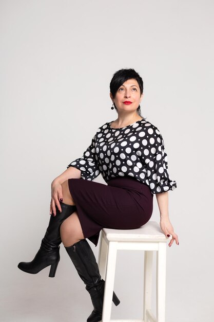 Woman posing in the studio on a white background in office clothes