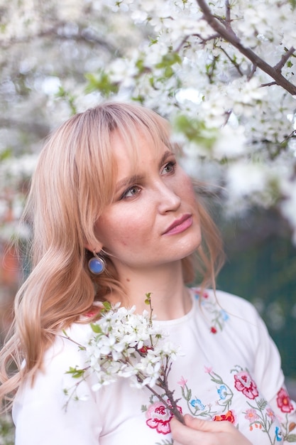 woman posing under a tree with flowers