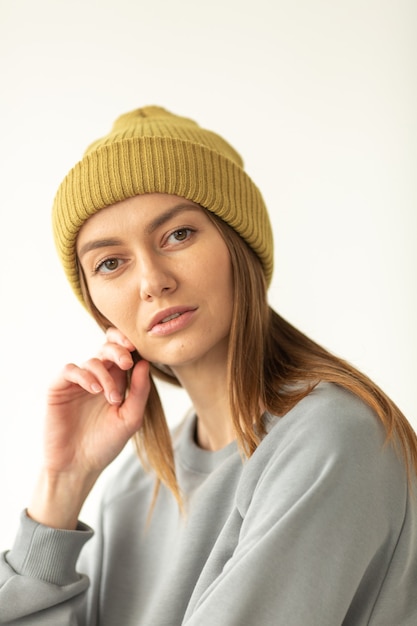 Woman posing in winter hat isolated