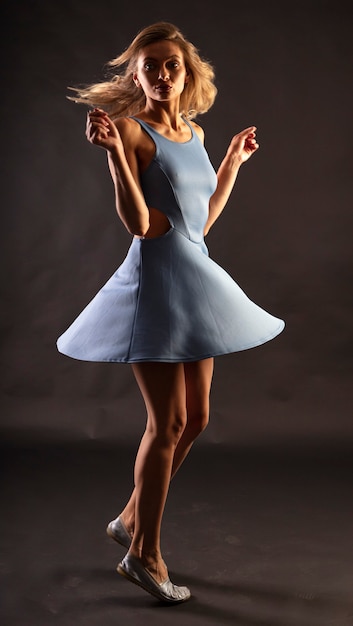 woman posing with dress on black