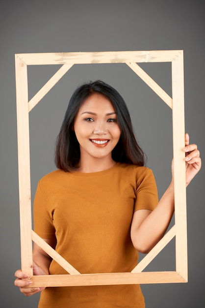 Woman posing with frame