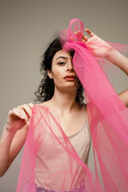 Woman posing with pink veil medium shot