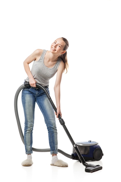 Woman posing with vacuum cleaner over white