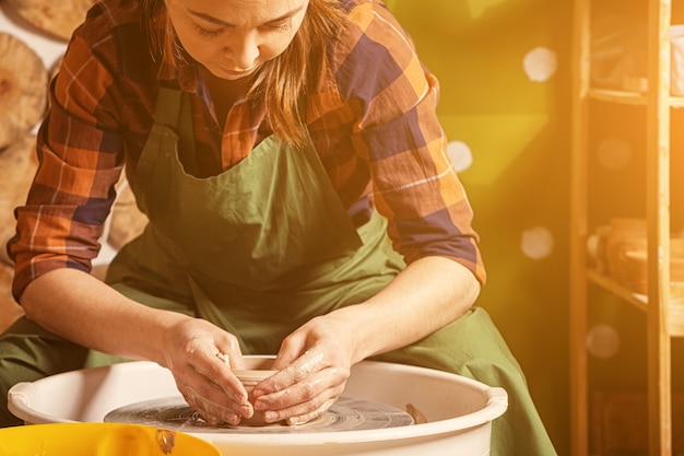 Woman potter sculpts a clay 