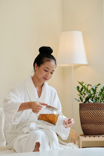 Woman Pouring Herbal Tea