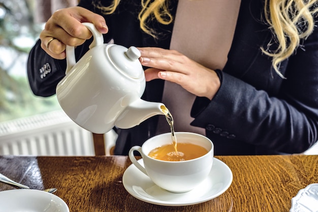 Woman pouring tea at a restaurant