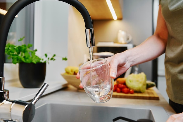 Woman pouring water in glass