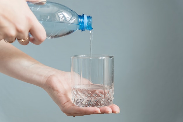 Woman pouring water into a glass