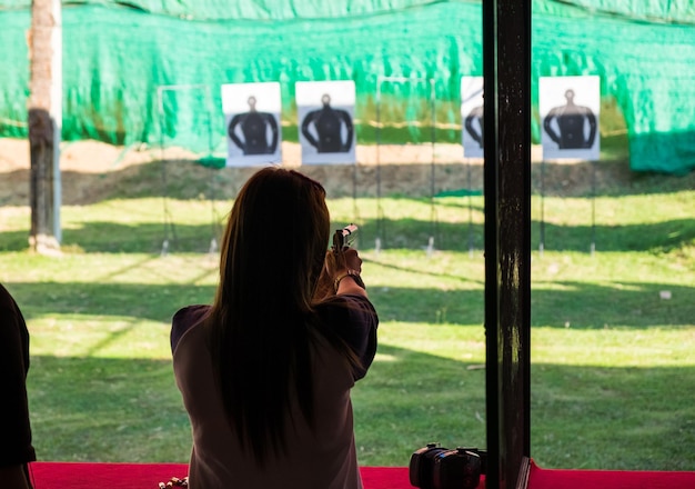 Woman practice shooting pistol