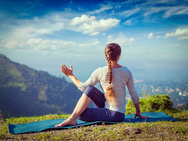 Woman practices yoga asana outdoors