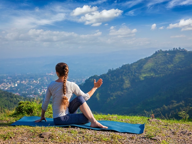 Woman practices yoga asana outdoors