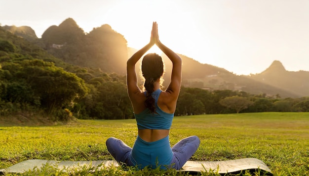 woman practices yoga and meditates in the lotus position on the field