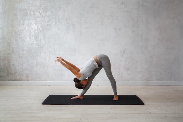 Woman practicing advanced yoga.