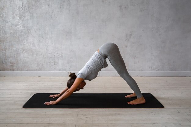 Two young women doing yoga asana double downward dog. Adho mukha svanasana  Stock Photo - Alamy