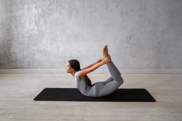 Woman practicing advanced yoga.