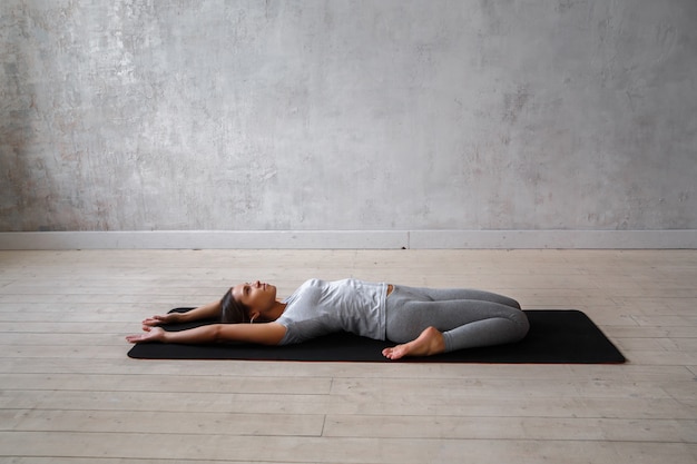 Woman practicing advanced yoga.