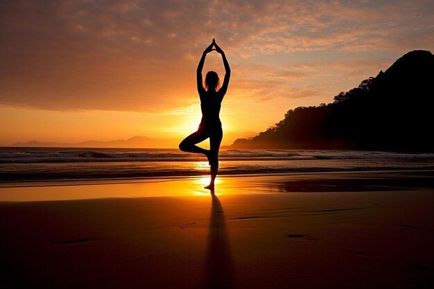 Woman practicing yoga on the beach at sunrise