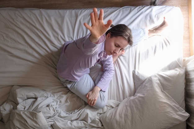 Woman practicing yoga in bedroom at the morning
