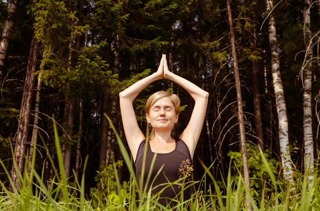 Woman practicing yoga in the fresh air. 