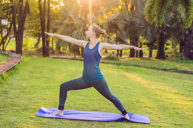 Woman practicing yoga in a tropical park.