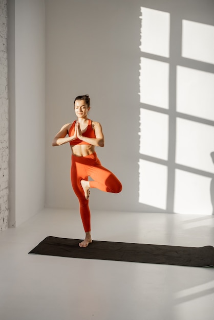 Woman practising yoga indoors