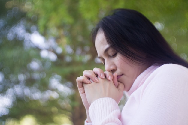 Woman praying  in the garden, Asian woman with white dress 