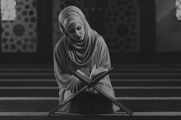 Woman praying in mosque and reading the quran