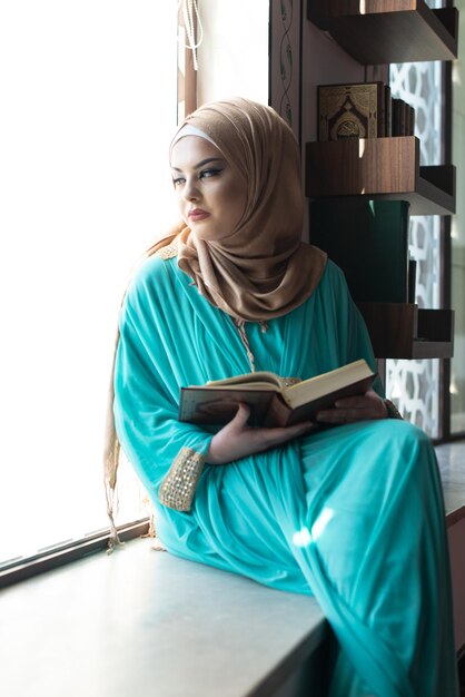 Woman praying in mosque and reading the quran