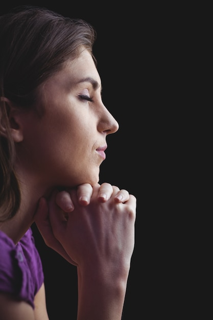 Woman praying with hands together